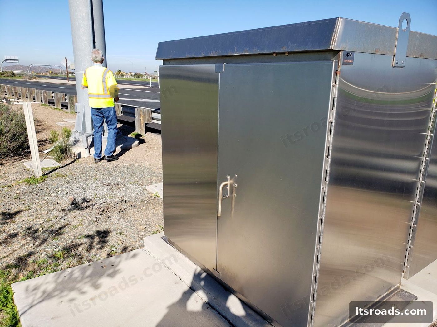 Stainless roadside cabinet installed beside a highway