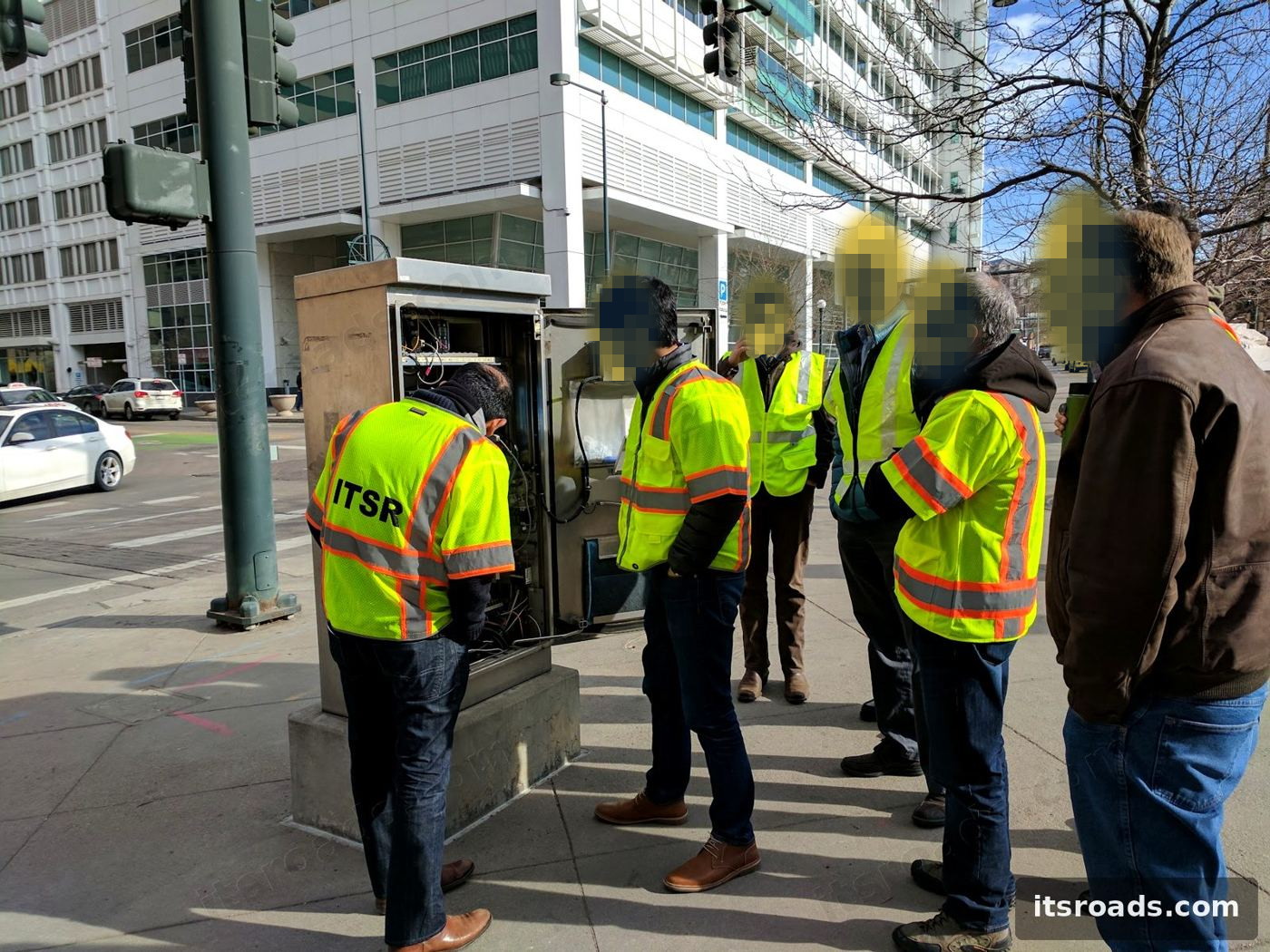 ITS Roads crew with city staff at a Denver intersection cabinet