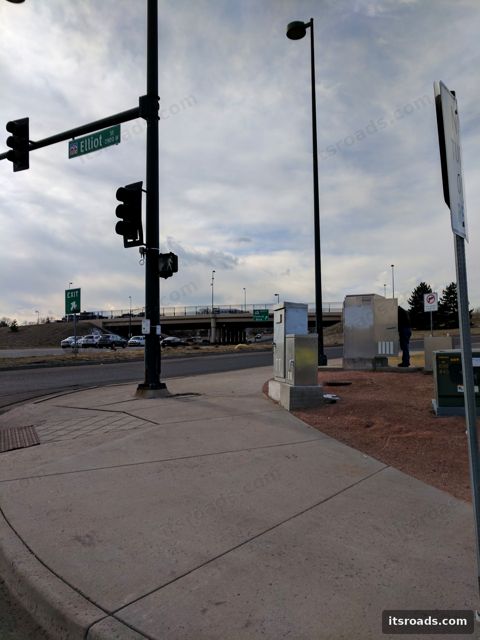 Signal pole and cabinet at an intersection under overcast sky