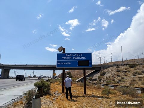 Streetline TPAS availability sign over a highway with technician below