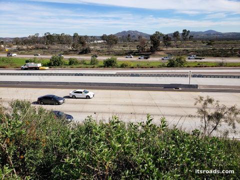Highway seen from a brush embankment