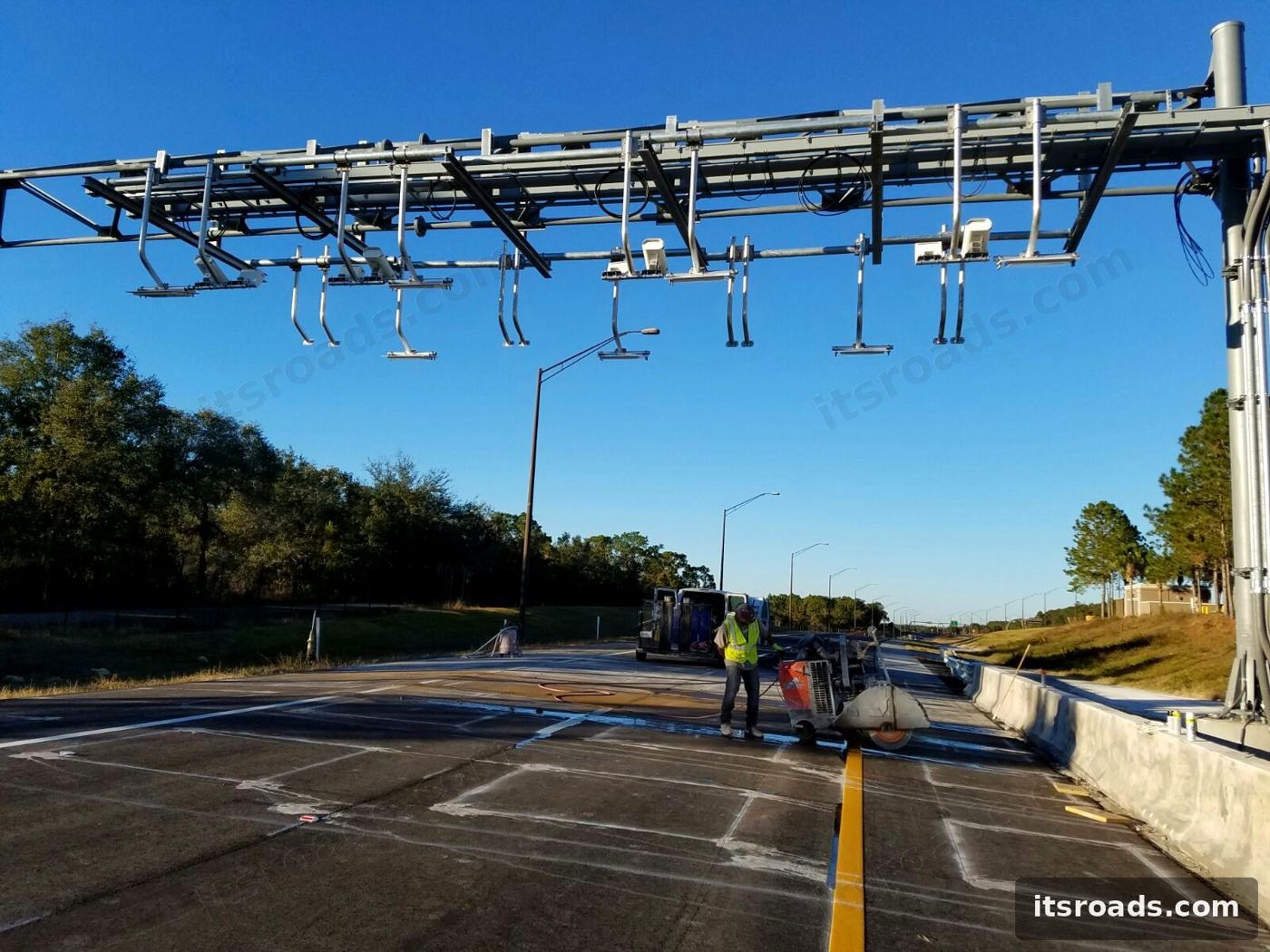 Toll gantry with readers, antennas and cameras seen from the roadside
